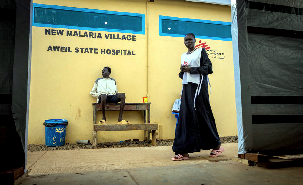 A patient sits next to a wall of the new malaria ward at Aweil State Hospital (© Isaac Buay)
