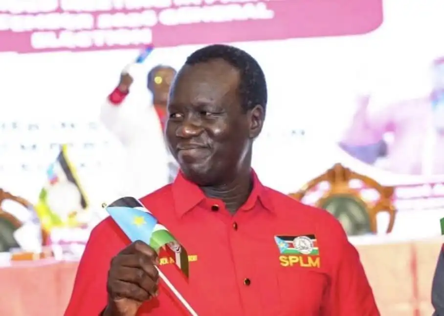 Akol Paul Kordit holding South Sudan's flag at an SPLM event, 2026 (Photo Credit: Wikimedia/Wikipedia)