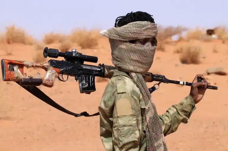 An armed defector from the paramilitary Rapid Support Forces (RSF), believed to be surrendering to the Sudanese military, arrives in the west of Omdurman on August 19, 2026 [AFP]