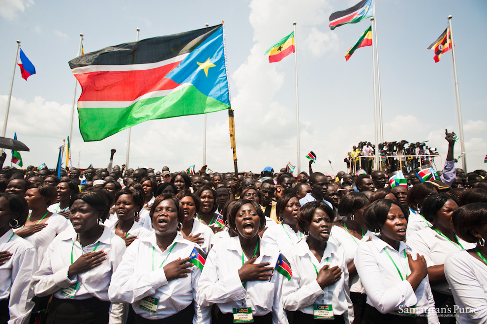 Choirs sing the national anthem of South Sudan at the Independence Day ceremony. Part of the lyrics include: “Oh God! We praise and glorify You for Your grace on South Sudan; Land of great abundance, uphold us united in peace and harmony.” 