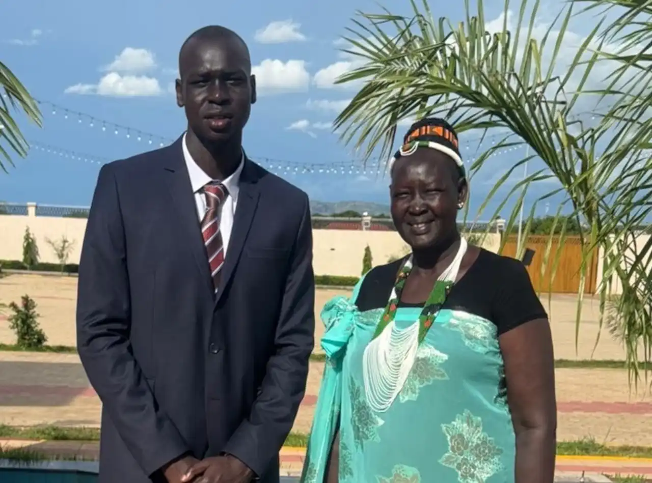 John Bol Ajak with his mother in South Sudan. They were attending his uncle's wedding after he returned home (Courtesy of John Bol Ajak)