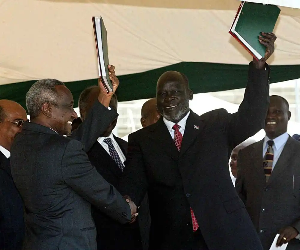 Late Dr. John Garang and Ali Osman Taha during the signing of the Juba Peace Agreement January 2005 AFP