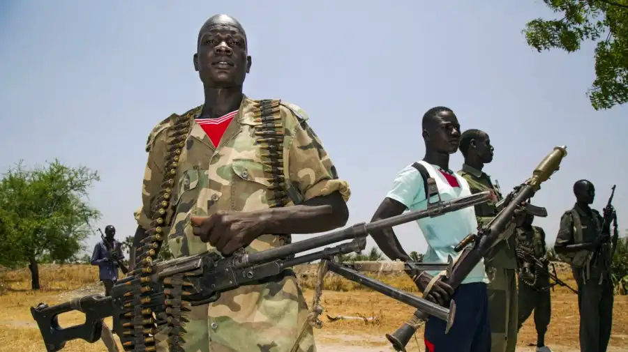Members of the opposition troops hold weapons near their base in Thonyor, in Leer county, on April 11, 2017 (Albert Gonzalez Farran/AFP via Getty Images)