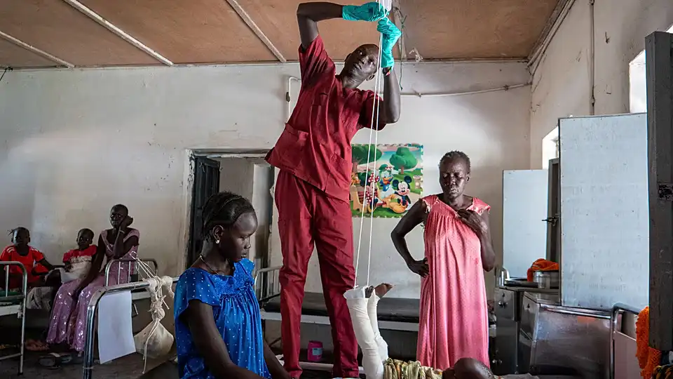 Nyayual Chuol, right, watches her 18-month-old grandson Kool Gatyen Pajock, who was shot during the conflict-hit state (Copyright © africanews / AP Photo)