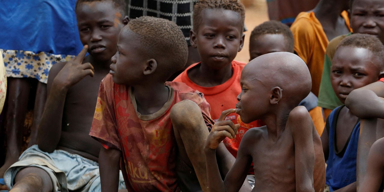 Orphans and children separated from their parents in Kadugli gather to eat boiled leaves at an IDP Camp within the Sudan People's Liberation Movement-North (SPLM-N) controlled area in Boram County, Nuba Mountains, South Kordofan, Sudan June 22, 2024 (Reuters)
