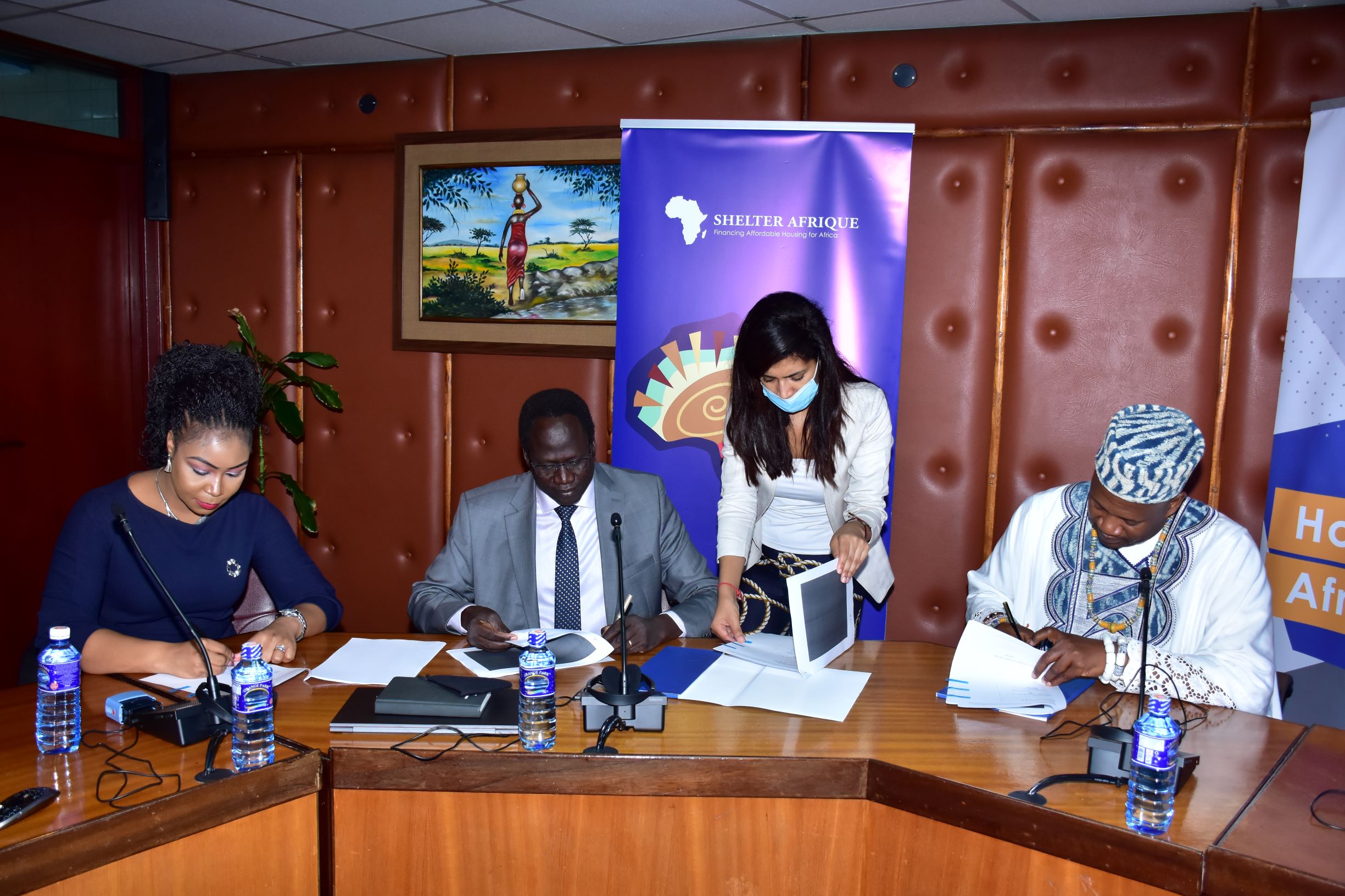 Triangle Real Estate Chief Executive Officer Amb. Arop Deng Kuol, and  Shelter Afrique Chief Executive Officer Andrew Chimphondah sign the USD1.5bn housing deal in Nairobi witnessed by Benchmark Solutions Managing Director Laura Akunga  and Shelter afrique's head of legal Houda Boudlali