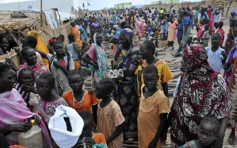 Refugees from South Sudan wait to be settled outside the Khour Al Waral refugee camp in Al Salam locality