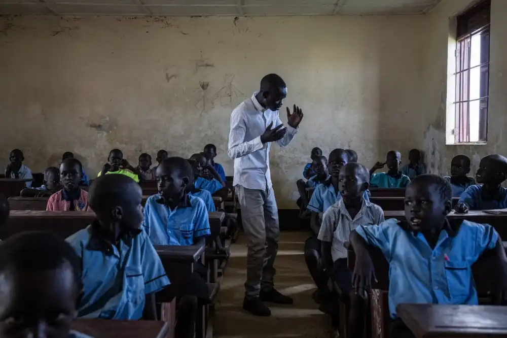 Simon Oba a university student volunteers at the school (Photograph by Ed Ram)