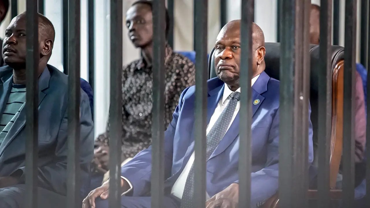 South Sudan's opposition leader and former vice-president Riek Machar (R) sits in the dock with his former deputy chief of staff during the third session of his trial at Freedom Hall in Juba, on September 24, 2025 (Picture: Peter Louis Gume/AFP)