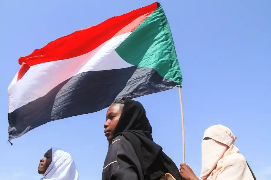 Sudanese Students from schools in the East Nile region of the capital, hold up the Sudan flag, during a protest against violations committed by the Rapid Support Forces (RSF) against the people of El- Fasher, in Khartoum on November 3, 2025. [Ebrahim Hamid / AFP /Getty Images]