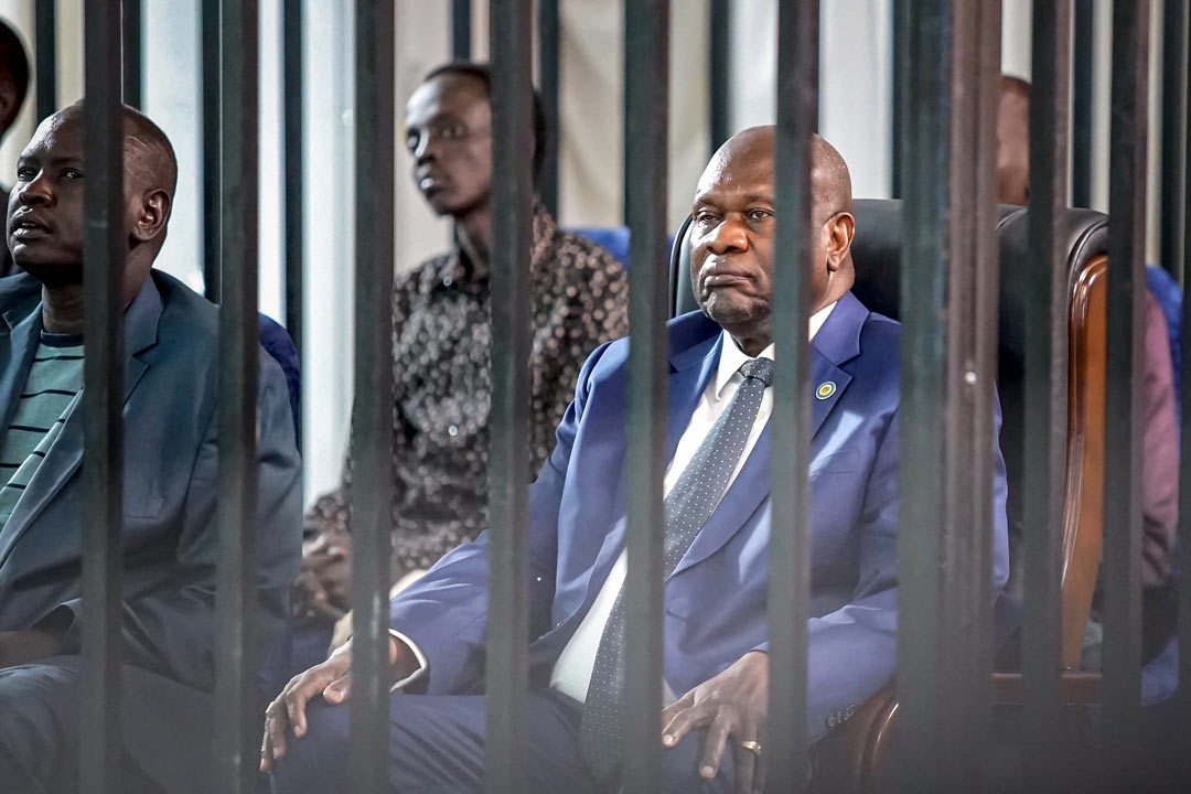 Sudan's opposition leader and former vice-president Riek Machar (R) sits in the dock with his former deputy chief ofhe third session of his trial at Freedom Hall in Juba, on September 24, 2025 (Peter Louis GUME / AFP)