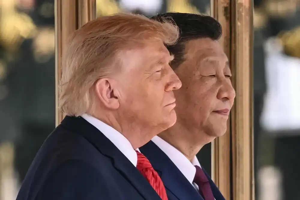 Trump and Xi stand for their countries' national anthems during Thursday's welcome ceremony at the Great Hall of the People (Photo Credit: Brendan Smialowski/AFP/Getty Images)